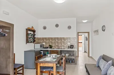 a kitchen and living room with a table and chairs at Summer Paradise Stegna Rhodes in Archangelos