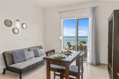 a living room with a couch and a table at Summer Paradise Stegna Rhodes in Archangelos