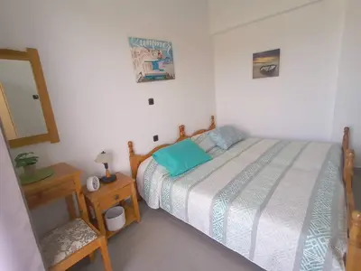 a small bedroom with a bed and a night stand at ZOGRAFOS 1 in Haraki