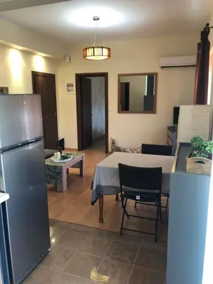 a kitchen and living room with a table and a refrigerator at MATREL Home 2 in Rhodes Town
