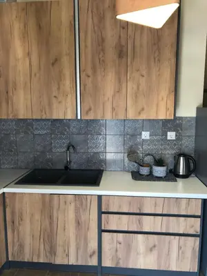 a kitchen with a sink and wooden cabinets at MATREL Home 2 in Rhodes Town