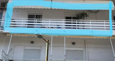 a blue balcony on a building with a street light at MATREL Home 2 in Rhodes Town