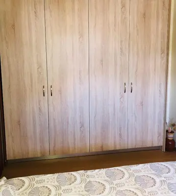 a row of wooden cabinets in a room at MATREL Home 2 in Rhodes Town
