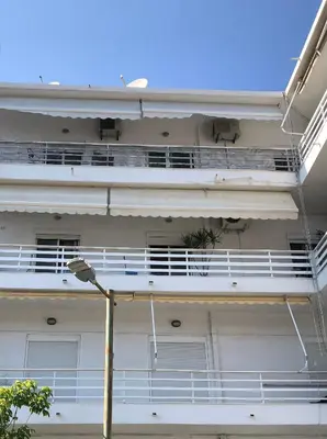 a white building with balconies and a street light at MATREL Home 2 in Rhodes Town