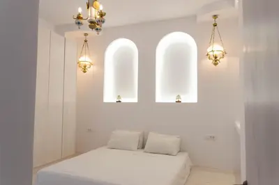 a white room with two windows and a bed at Villa Iliousa Princess in Psinthos