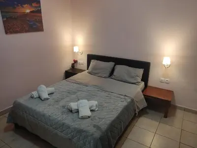 a bedroom with a bed with towels on it at Nikolettas Studios Traditional House in Paradeísion