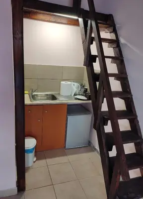 a kitchen with a staircase leading into a kitchen with a sink at Nikolettas Studios Traditional House in Paradeísion