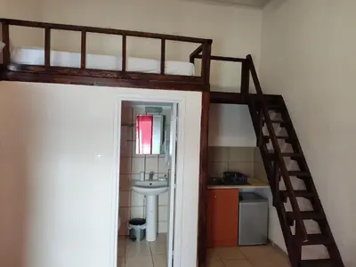 a room with a bunk bed and a sink at Nikolettas Studios Traditional House in Paradeísion
