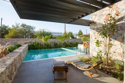 a swimming pool in a yard with a patio furniture at DeLight Luxury Rooms in Faliraki