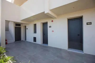 a row of doors on the side of a building at DeLight Luxury Rooms in Faliraki