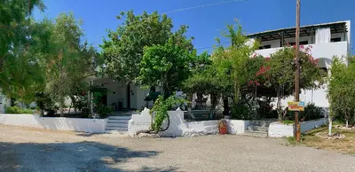 a house with trees and stairs in front of it at Anastasia's Garden in Archangelos