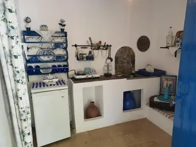 a kitchen with blue and white dishes on the wall at Anastasia's Garden in Archangelos
