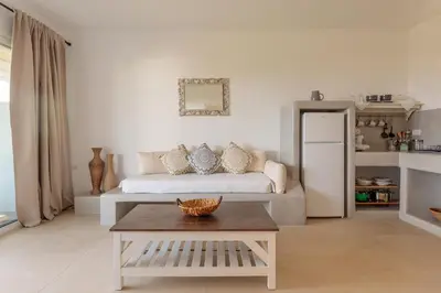 a living room with a bed and a coffee table at Anastasia's Garden in Archangelos
