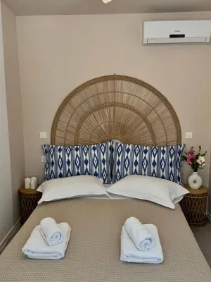 a bed with two towels on top of it at Nerea in Archangelos