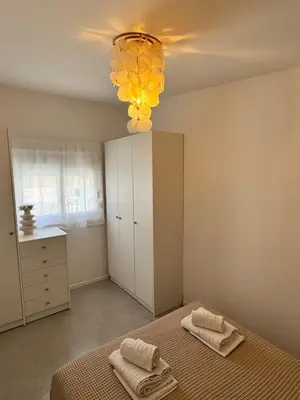 a bedroom with a bed and a chandelier at Nerea in Archangelos