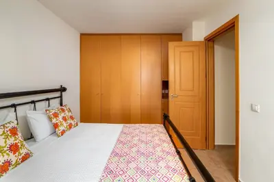a bedroom with a bed and a wooden closet at Aegean Blue Villa's - All Inclusive & Water park in Kalathos