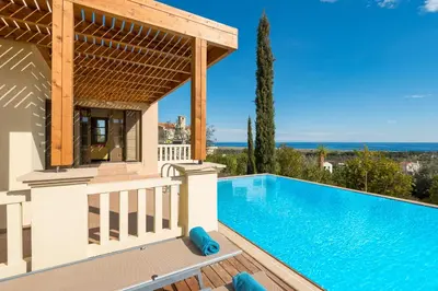 a villa with a swimming pool and a gazebo at Aegean Blue Villa's - All Inclusive & Water park in Kalathos