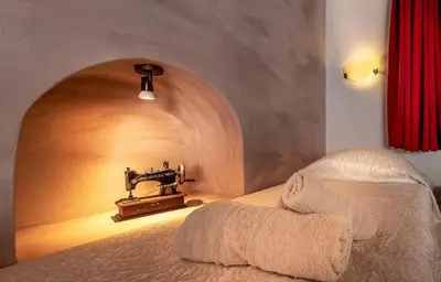 a bedroom with a bed with a sewing machine on it at Villa Amalia in Líndos
