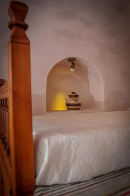 a room with a bed with a vase on it at Villa Amalia in Líndos