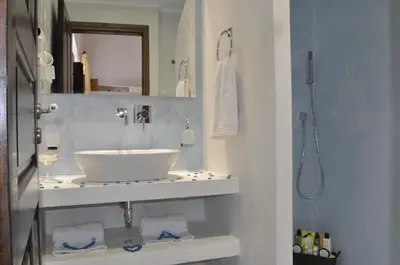 a bathroom with a white sink and a shower at Villa Amalia in Líndos