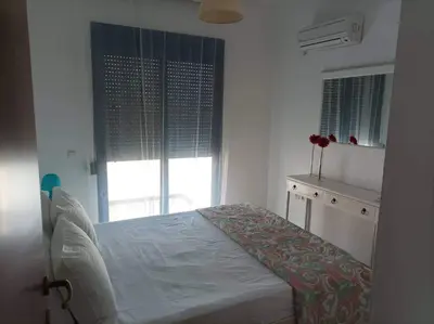 a bedroom with a bed and a window at Villa Poseidon Blue in Rhodes Town