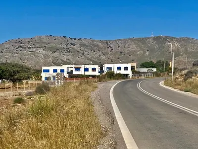 an empty road with a mountain in the background at Villa Poseidon Blue in Rhodes Town