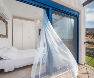 a bedroom with a bed and a large window at Villa Poseidon Blue in Rhodes Town