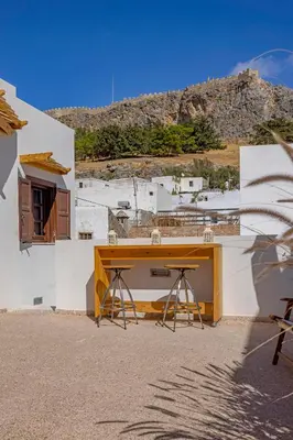 a table on the side of a building at Filigrana Villa Lindos in Líndos