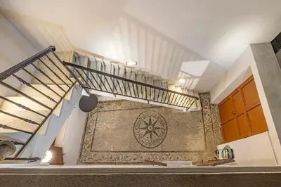 a staircase in a house with a tile wall at Filigrana Villa Lindos in Líndos