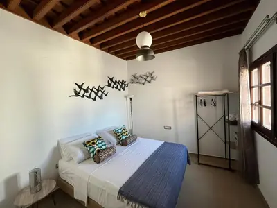 a bedroom with a bed with a blue blanket at Filigrana Villa Lindos in Líndos
