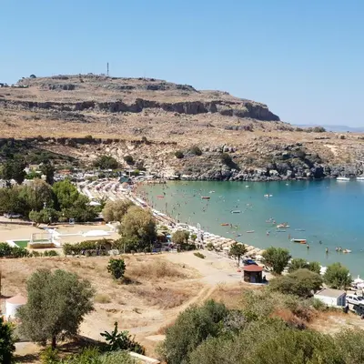 a view of a beach with boats in the water at Lindos Luxury Belfry Apartment in Líndos