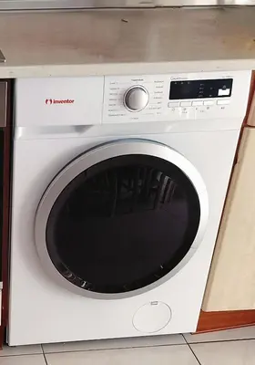 a white washing machine sitting in a kitchen at Periklis House in Ixia