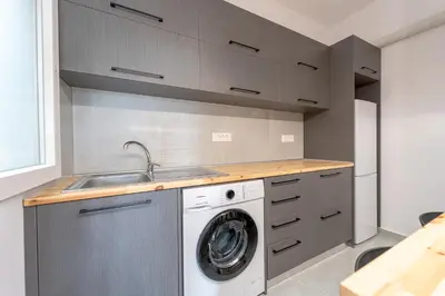 a kitchen with a washing machine and a sink at Aletreo, Rhodes in Rhodes Town