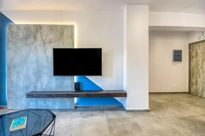 a flat screen tv on a wall in a room at Aletreo, Rhodes in Rhodes Town