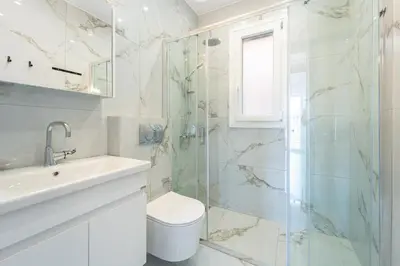 a bathroom with a shower and a toilet and a sink at Aletreo, Rhodes in Rhodes Town
