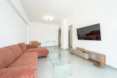 a living room with a couch and a tv at Aletreo, Rhodes in Rhodes Town