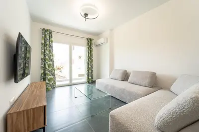 a living room with a couch and a table at Aletreo, Rhodes in Rhodes Town