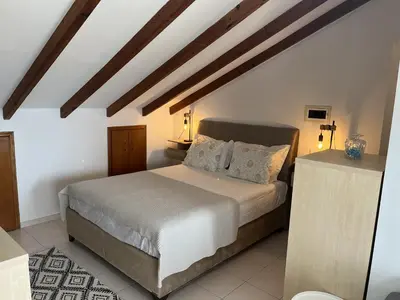 a bedroom with a large bed in a room at Sea View Loft in Koskinou