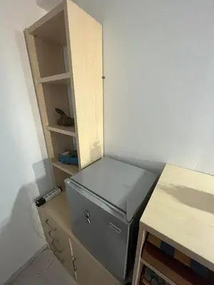 a desk with a gray briefcase next to a cabinet at Sea View Loft in Koskinou