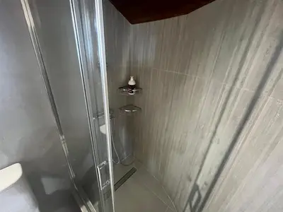 a shower with a glass door in a bathroom at Sea View Loft in Koskinou