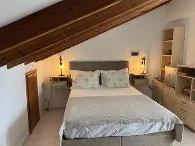 a bedroom with a large bed with two pillows at Sea View Loft in Koskinou