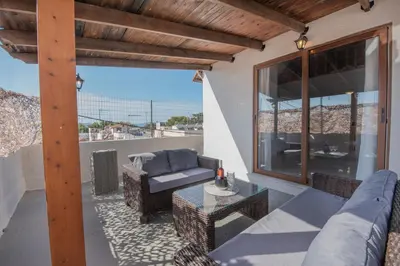a patio with a couch and a table at Cozy Loft with Private Terrace in Kremasti
