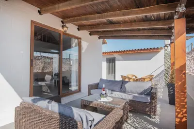 a patio with wicker chairs and a table at Cozy Loft with Private Terrace in Kremasti