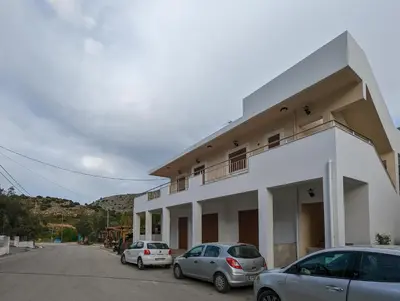 a white building with cars parked in front of it at Tharenos home in Émbonas