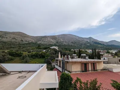 a view from the roof of a house with mountains in the background at Tharenos home in Émbonas