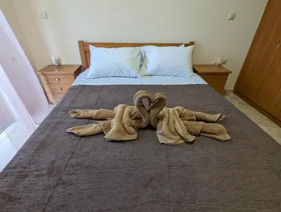 a pair of towels are laying on a bed at Tharenos home in Émbonas