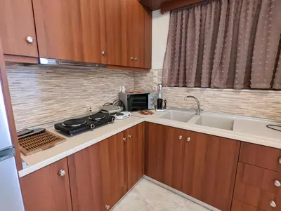 a small kitchen with a sink and a stove at Tharenos home in Émbonas