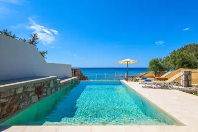 a swimming pool with a view of the ocean at Anima Maris in Kiotari