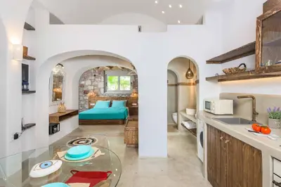 a kitchen and living room with a glass table at Anima Maris in Kiotari
