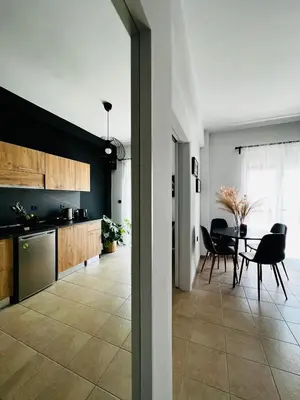 a kitchen and dining room with a table and chairs at DownTown Apartments in Rhodes Town
